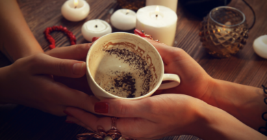 Hands swirling a teacup to settle the leaves for a tasseomancy reading.
