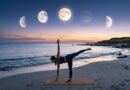 A woman practicing half moon pose on a yoga mat at a quiet beach during twilight, with different phases of the moon visible in the sky above the ocean.