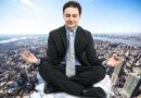 A calm businessman in a black suit meditating with closed eyes on a cloud above a busy cityscape, representing how to stay grounded, drop your guard, and stop being defensive during stressful interactions.